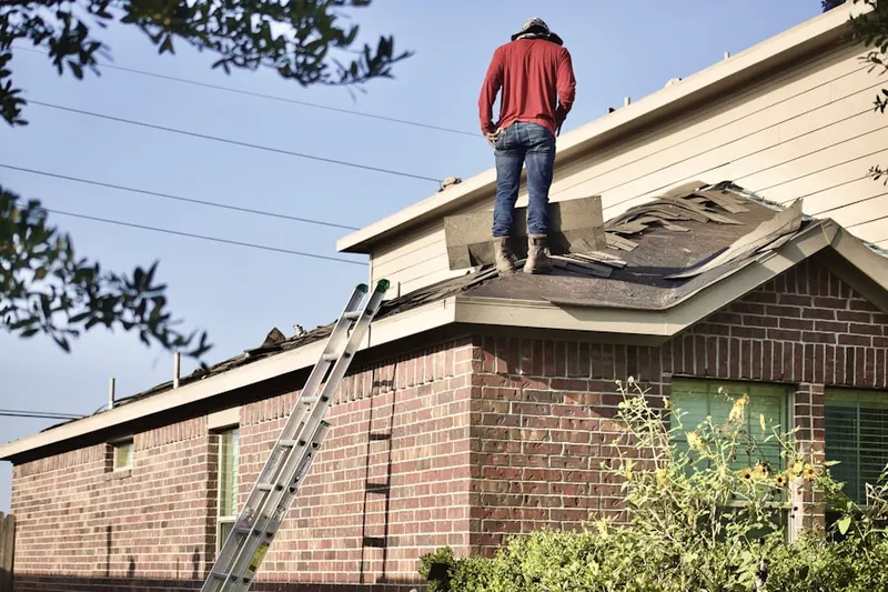 Professional roofer working on a residential roof in East Riverton